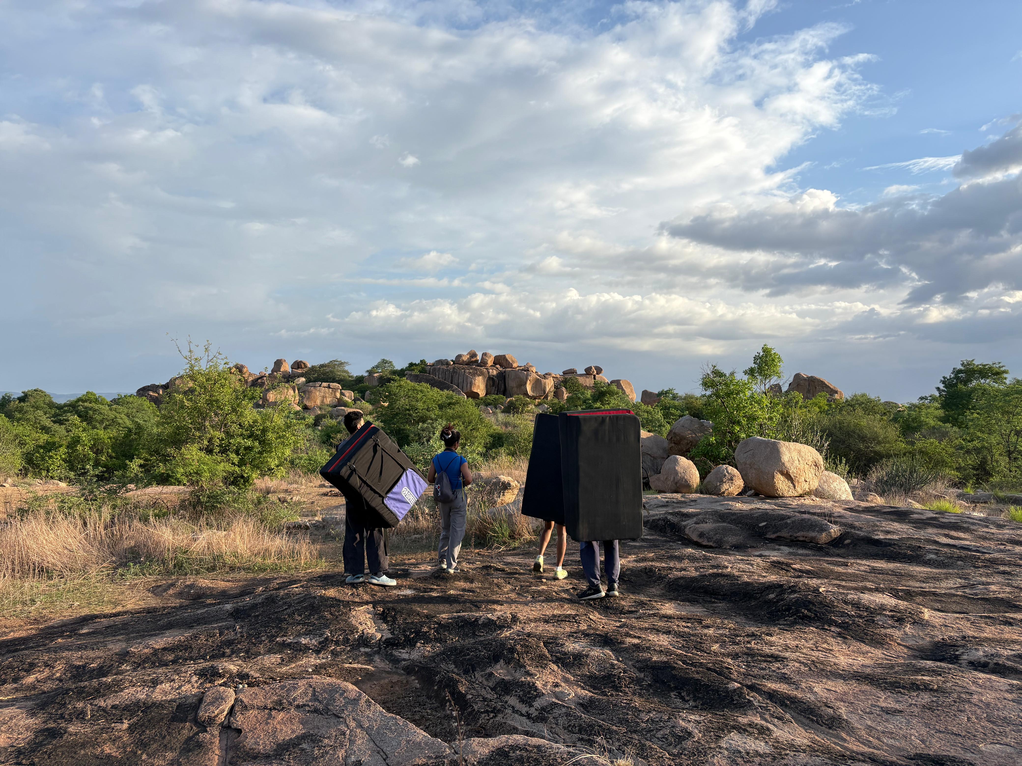 People standing in an open area trying to find Party Boulder Area